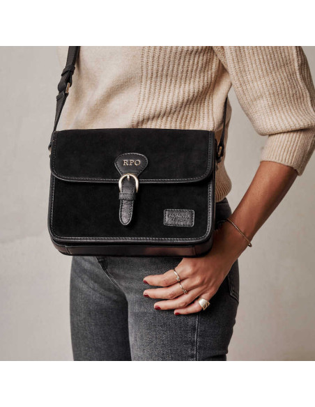 Bolsa satchel em camurça preta com fivela, vista frontal, usada na bandoleira, detalhe das iniciais personalizadas - MONPIEL