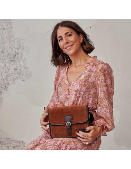 Leather suede satchel bag with buckle, paired with a dress, holding it with hands - MONPIEL