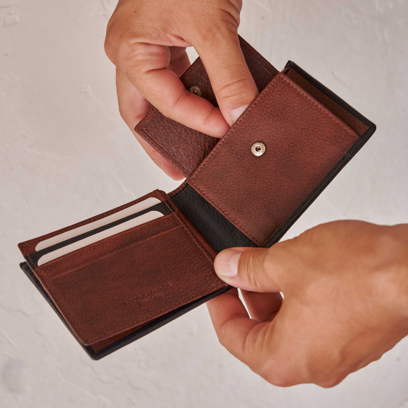 Brown leather wallet with coin purse and rubber detail, open with wall background - MONPIEL