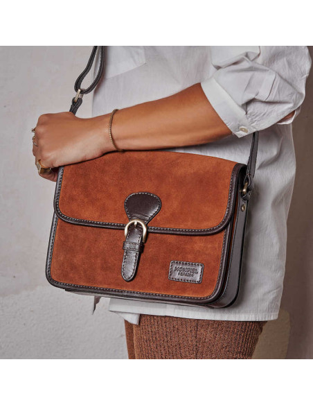 Leather suede satchel bag with buckle, hanging from the shoulder with front view - MONPIEL
