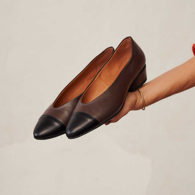 Brown leather bicolor pointed toe ballerina with heels, resting on the hand - MONPIEL