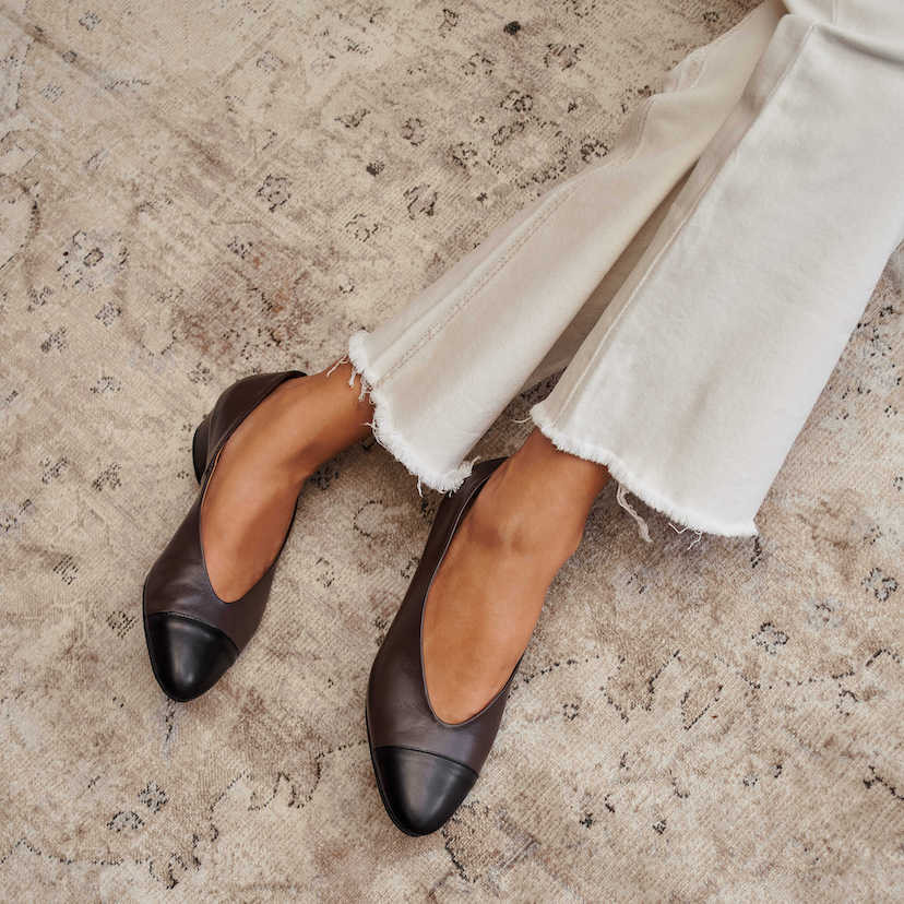 Brown leather bicolor pointed toe ballerina with heels, legs crossed on a carpet - MONPIEL
