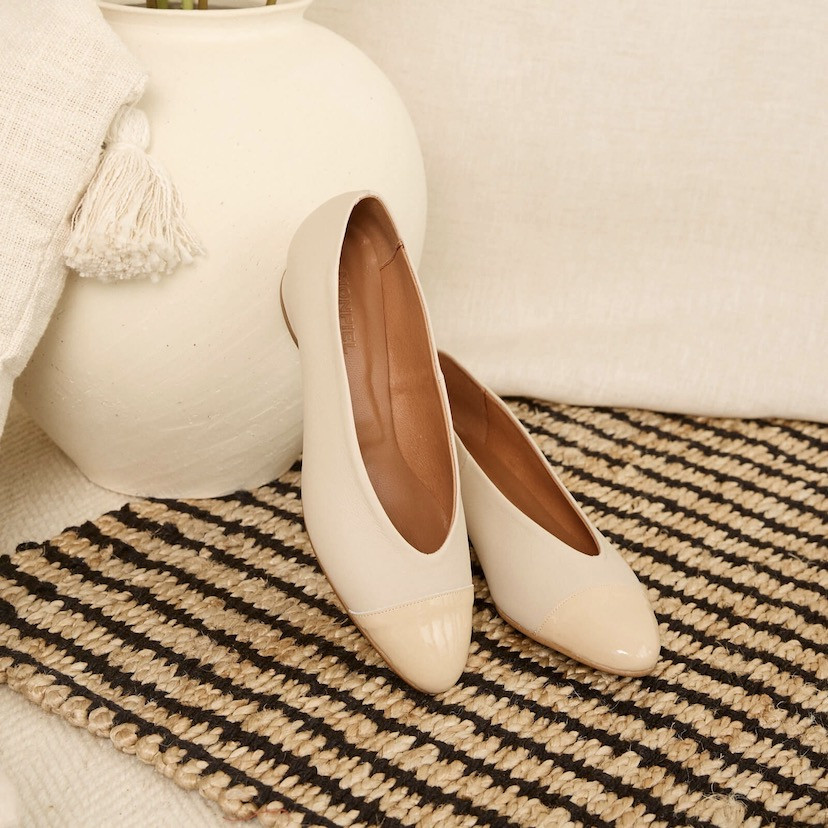 Beige/beige patent leather bicolor pointed toe ballerina flats, resting on a vase - MONPIEL