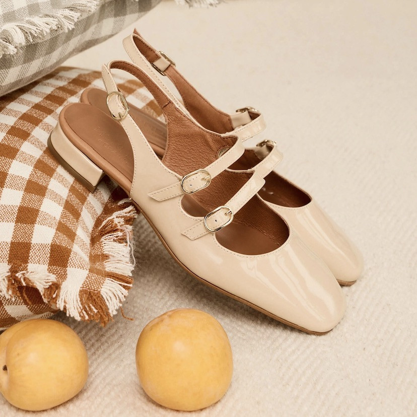 Cream Lolina backless Mary Janes, perspective view, resting on a cushion - MONPIEL