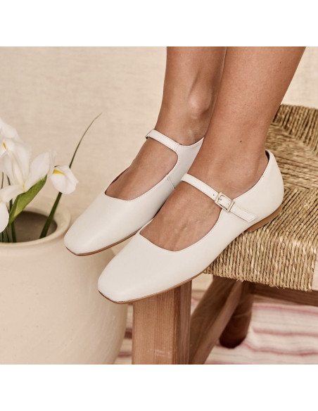 Carlota strap Mary Janes in ice color, perspective view, heel resting on chair in foreground - MONPIEL Carlota strap Mary Janes in ice color, perspective view, heel resting on chair in foreground - MONPIEL