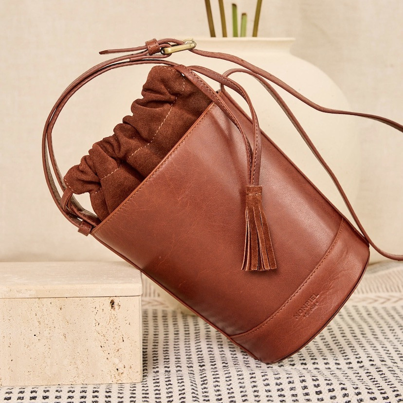 Small Havana leather round cube bag, front view, tilted, resting - MONPIEL