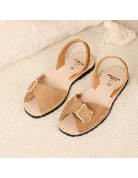 Menorcan leather sandals with buckle in tan color, perspective view on a rug - MONPIEL Menorcan leather sandals with buckle in tan color, perspective view on a rug - MONPIEL