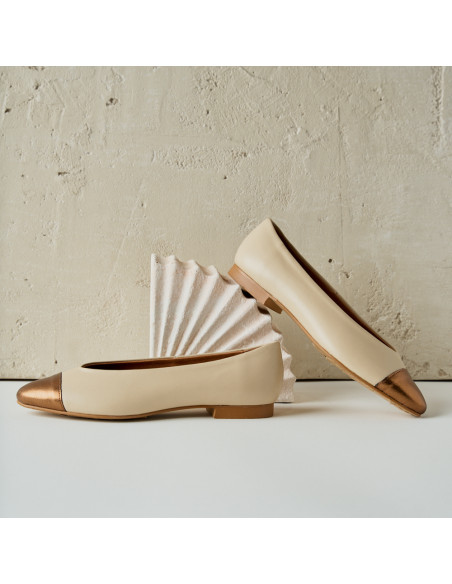 Ameliè flat ballerina with metallic beige/copper toe, side profile view, heel resting on decoration - MONPIEL Ameliè flat ballerina with metallic beige/copper toe, side profile view, heel resting on decoration - MONPIEL