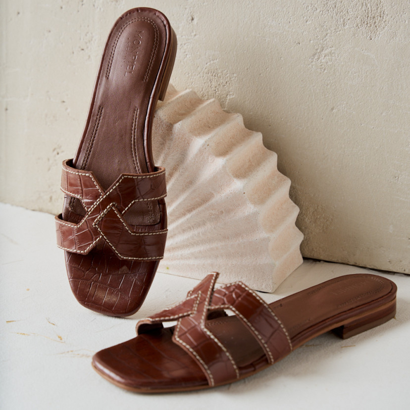 Carmina leather toe-post sandal in coco leather, perspective and front view, resting on decoration - MONPIEL