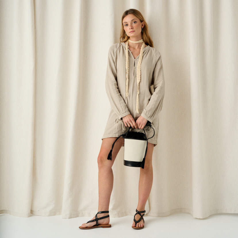 Small black canvas bucket bag held by the handle, front view, full shot - MONPIEL