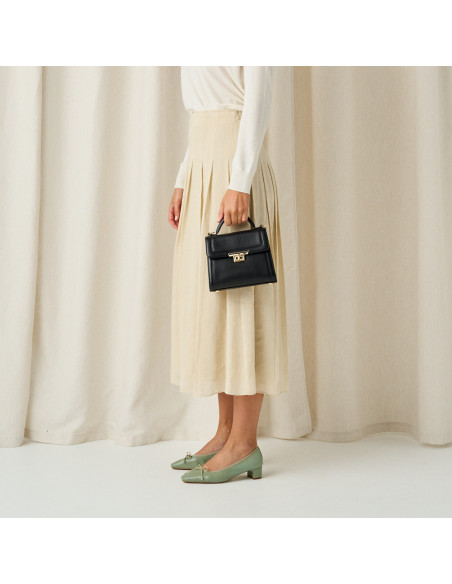 Small black leather 60's handbag for women, medium shot with model in profile - MONPIEL