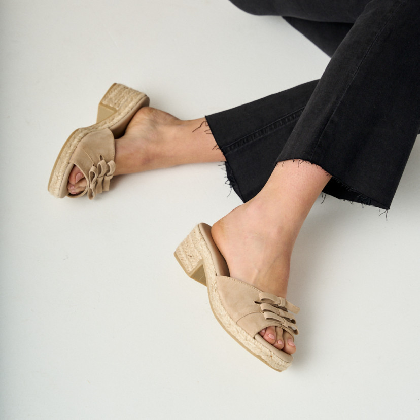 Brisa low heel espadrille with bow in beige, side view, crossed legs on the floor - MONPIEL
