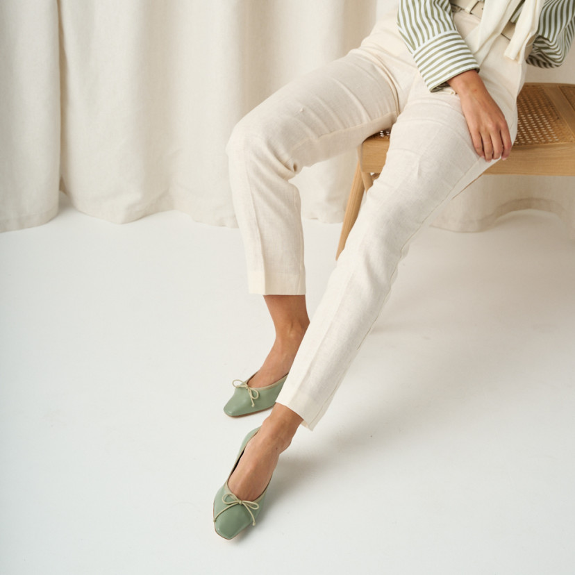 Manuela low heel bow flat slipper in mint green, medium shot with white linen trousers - MONPIEL