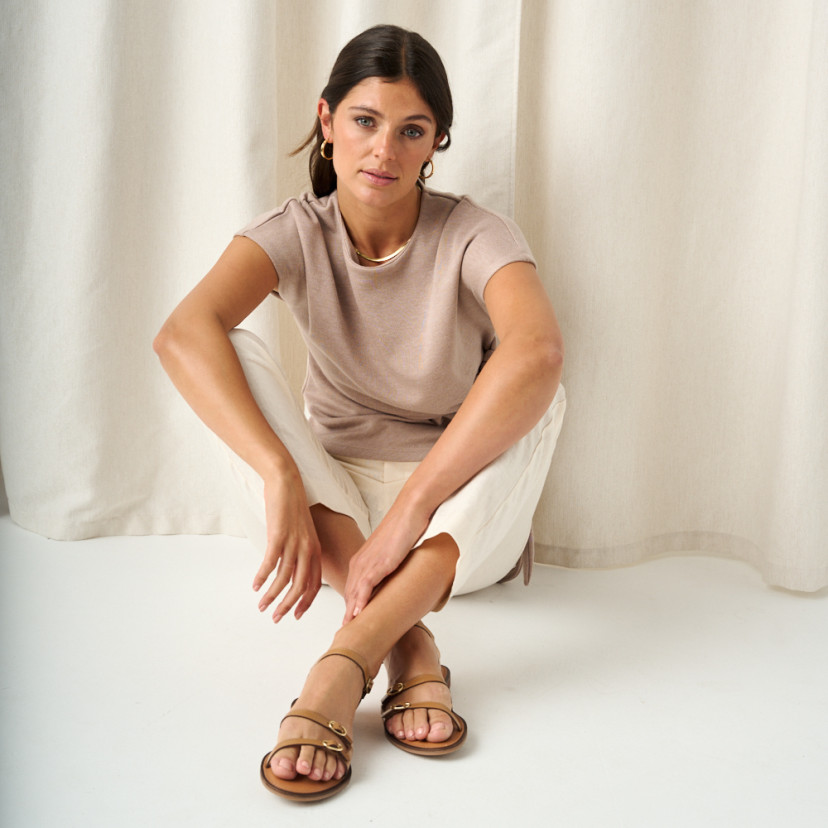 Amalfi buckle sandal in leather colour with front view, crossed feet with arms resting on legs - MONPIEL