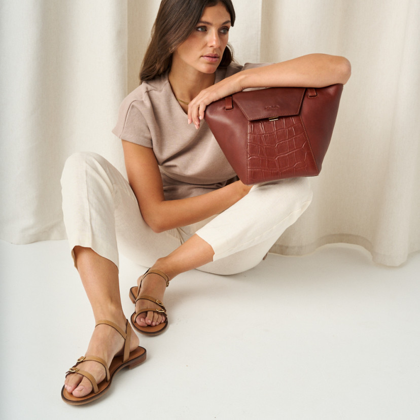 Women's leather tote bag Paris coco in brown with front view, full shot, resting on knee - MONPIEL