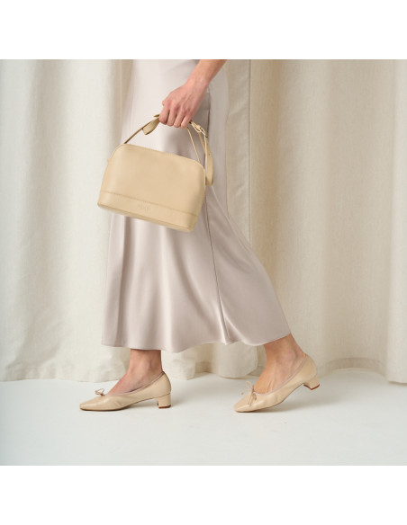 Manuela low heel bow flat slipper in beige with side view walking, medium shot - MONPIEL