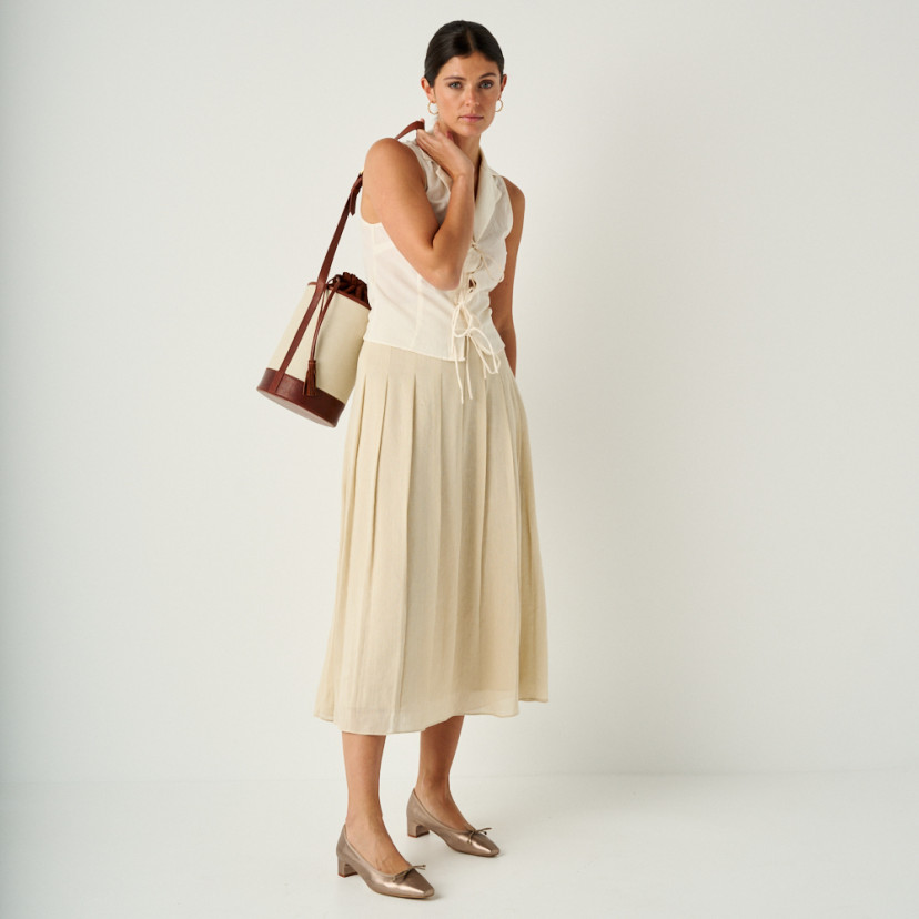 Manuela low heel bow flat slipper in cappuccino bronze with perspective view, full shot of the model with bag on shoul - MONPIEL