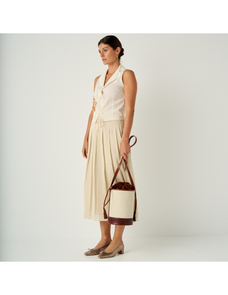 Bronze cappuccino-colored Manuela bow ballet flat with a perspective view and general shot, with a bucket bag in hand - MONPIEL