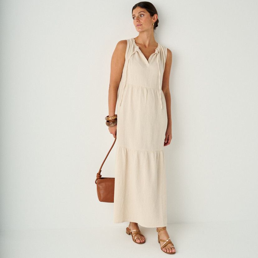 Rodios low heel platinum strap sandal in leather color, full shot with leather bag in hand - MONPIEL