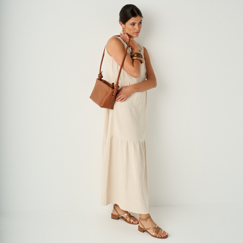 Rodios low heel platinum strap sandal in leather color with perspective view in full shot, leather bag on shoulder - MONPIEL