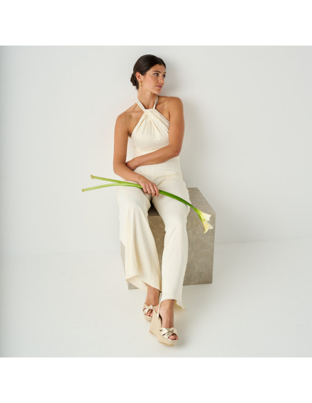 Lyra wedge espadrille with knot in platinum in full shot with flower detail in hand - MONPIEL Lyra wedge espadrille with knot in platinum in full shot with flower detail in hand - MONPIEL