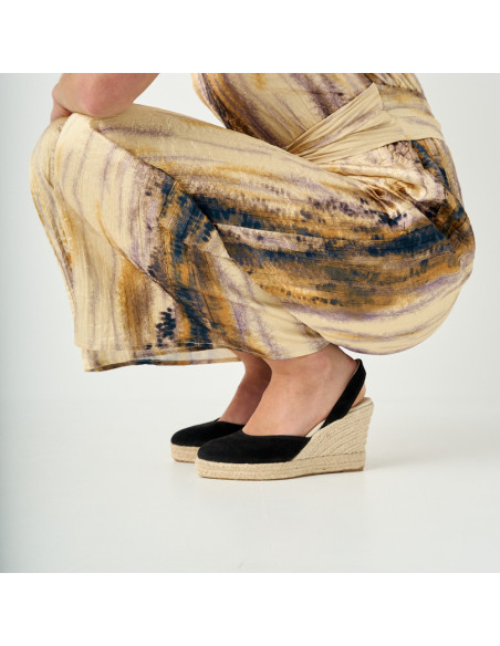 Black suede leather wedge espadrille with side view, model crouching, close-up of wedges - MONPIEL