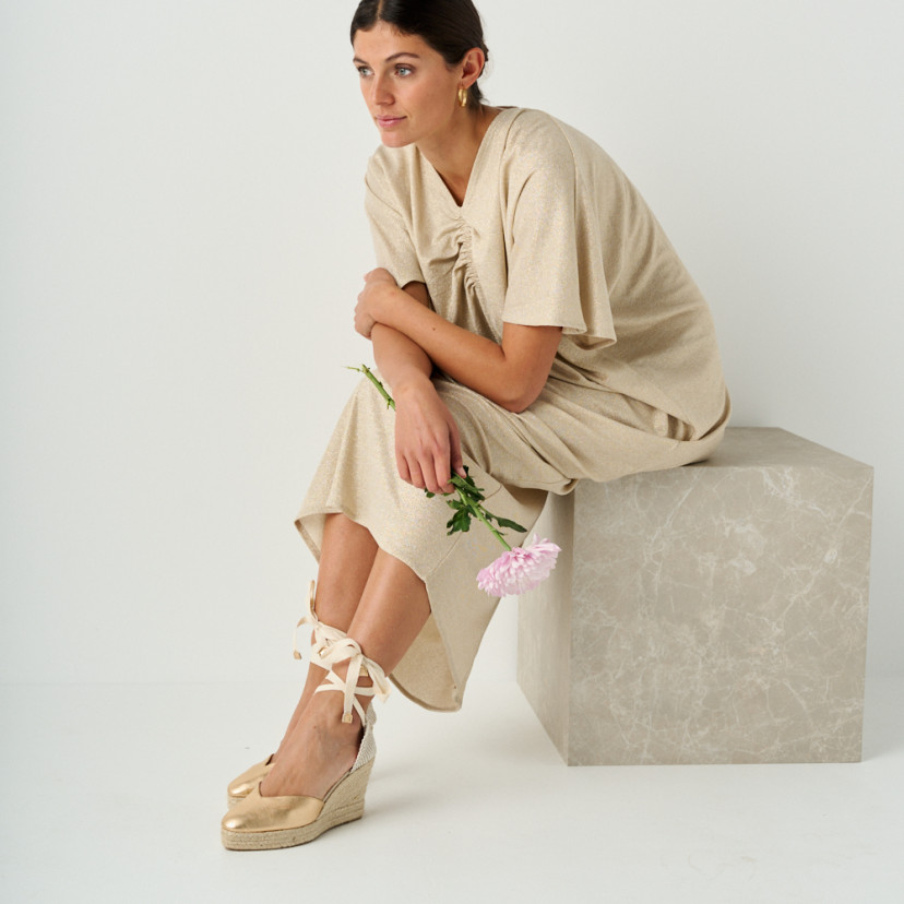Elba gold leather wedge espadrille with perspective view, model sitting on marble cube - MONPIEL