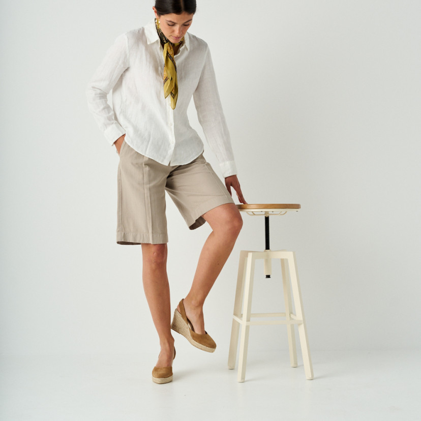 Leather suede wedge espadrille in leather color, full shot, model resting on stool - MONPIEL
