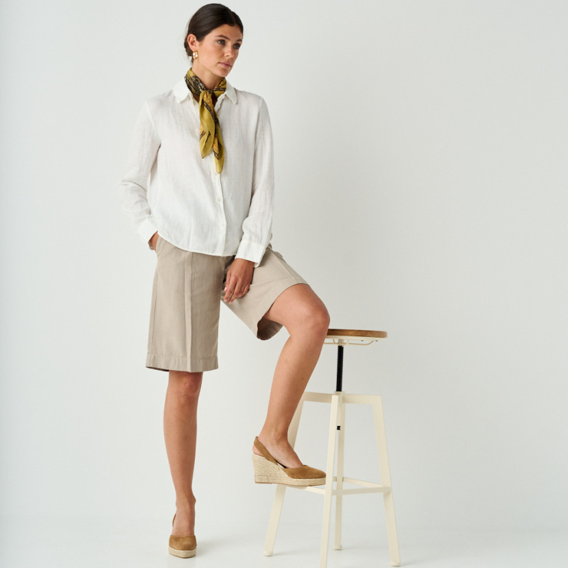 Leather suede wedge espadrille in leather color, full shot of model resting espadrille on stool - MONPIEL