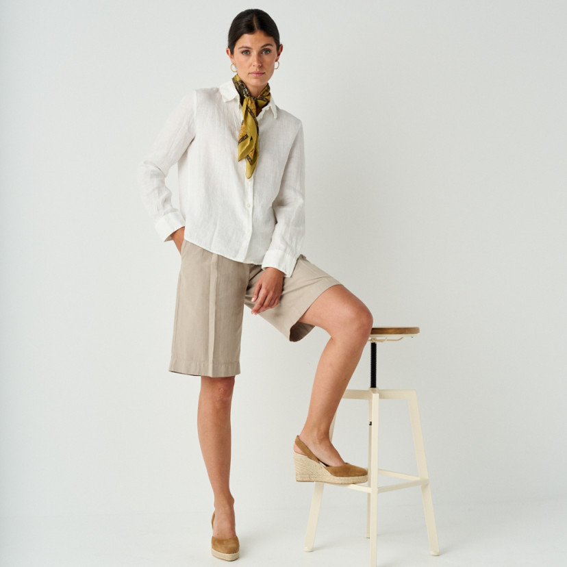 Leather suede wedge espadrille in leather color, full shot of model resting espadrille on stool, side view - MONPIEL