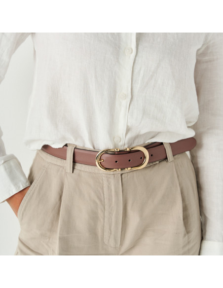 Double buckle women's leather belt in blush pink with front view over tailored trousers and blouse - MONPIEL