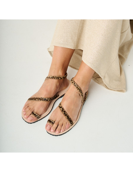 Animal print leather Milos strap sandals with feet resting in perspective and top view - MONPIEL