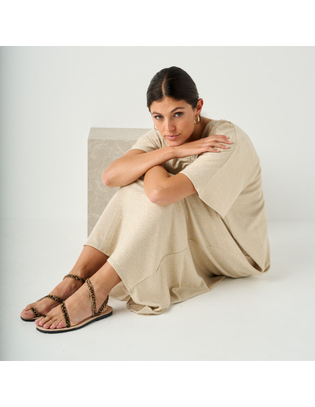 Animal print leather Milos strap sandals with perspective view and full-length shot of the model sitting on the floor - MONPIEL