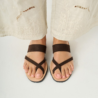 Nuts-colored Santorini Greek leather sandal, top view, resting on a chair - MONPIEL 2