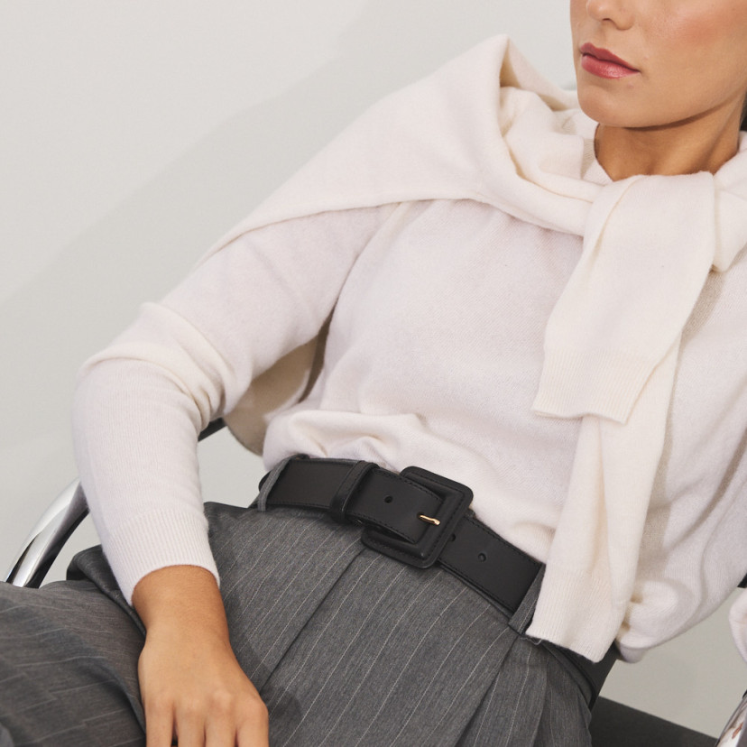 Wide women's leather belt with covered buckle in black, over striped pants - MONPIEL