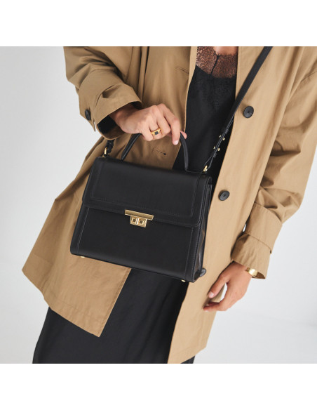 Borsa da donna in pelle anni '60 nera portata a tracolla, tenuta dal manico corto - MONPIEL