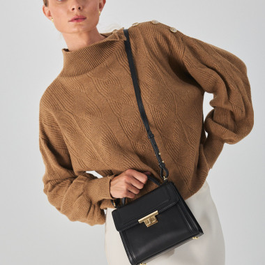 Small beige leather 60's handbag for women, front view, next to a flower - MONPIEL 2