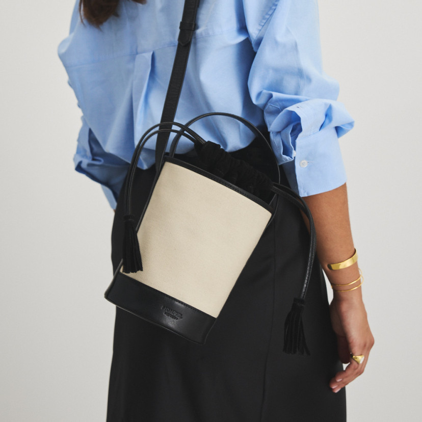 Small black canvas bucket bag worn over the shoulder, back view - MONPIEL