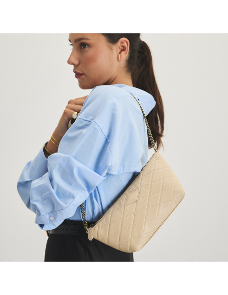 Small New York quilted leather bag for women in beige color, front view, hanging on the shoulder, tilted - MONPIEL