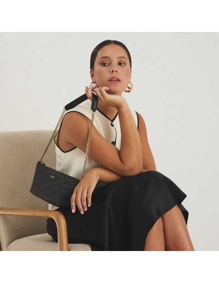 Small New York quilted leather handbag for women in black, hanging from the hand over the shoulder - MONPIEL