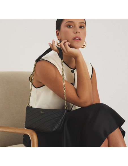 Small New York quilted leather handbag for women in black, hanging from the hand over the shoulder - MONPIEL