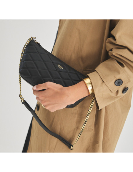 Small New York quilted leather handbag for women in black, front view, held in hand - MONPIEL