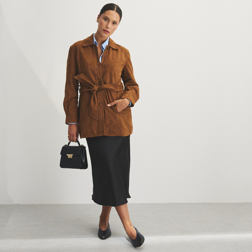 Camel suede trench coat, front view, mid shot with leather handbag in hand - MONPIEL