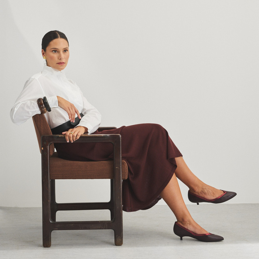 Estíbaliz heeled ballerina in burgundy leather, full shot of model sitting on the chair - MONPIEL