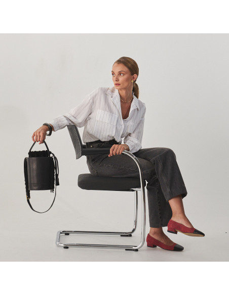 Bolsa bucket de couro com franjas pequena Roma na cor preta, vista frontal, segurada pela alça curta, plano geral de m - MONPIEL