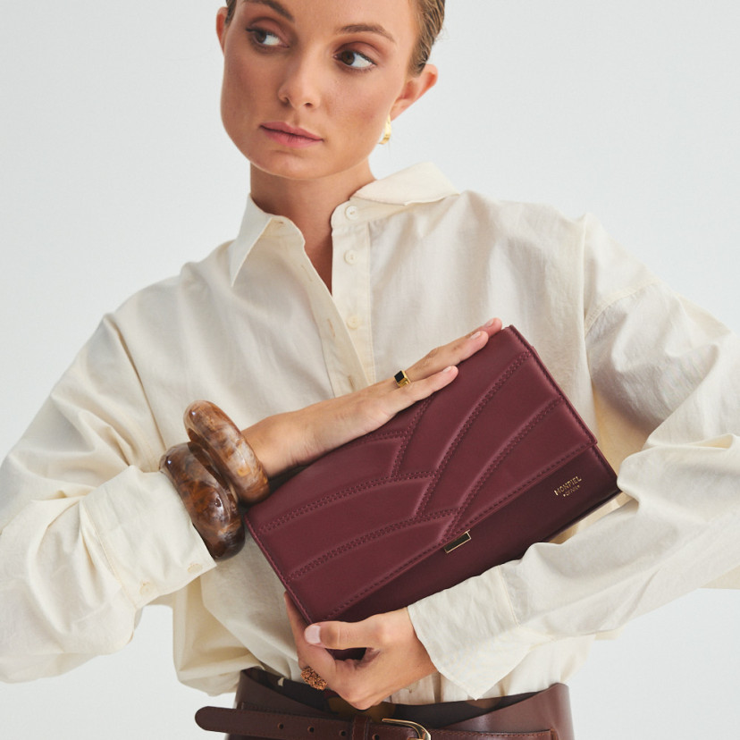 Venice burgundy leather handheld purse for women, held between the hands, close-up - MONPIEL