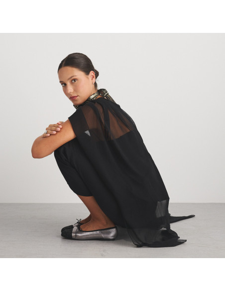 Valeria silver glitter-toe flat shoe, profile view of model sitting on the floor, wide shot - MONPIEL