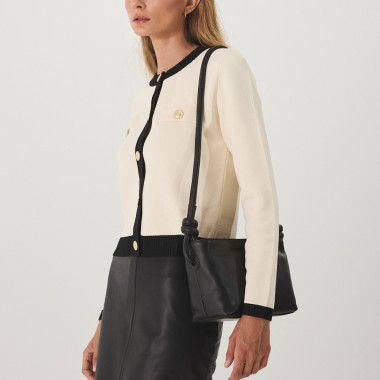 Small knot leather bag in taupe color with front view, held by the handle in hand - MONPIEL 2