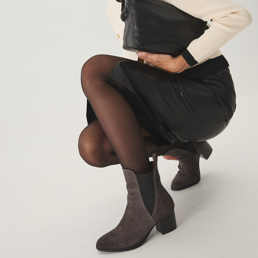 Marcela leather ankle boot in grey suede, model crouching with perspective view - MONPIEL