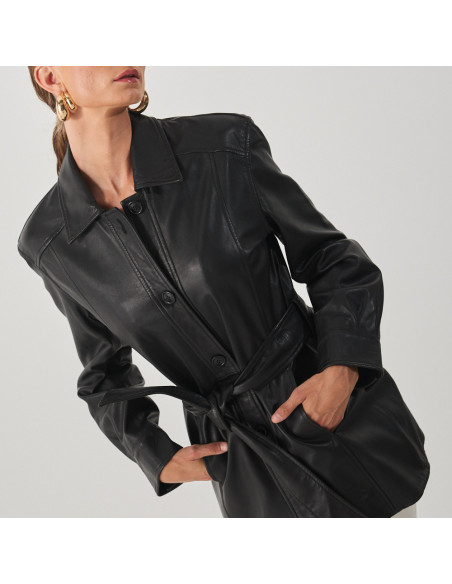 Black leather trench coat, medium shot, model with hands in pockets - MONPIEL